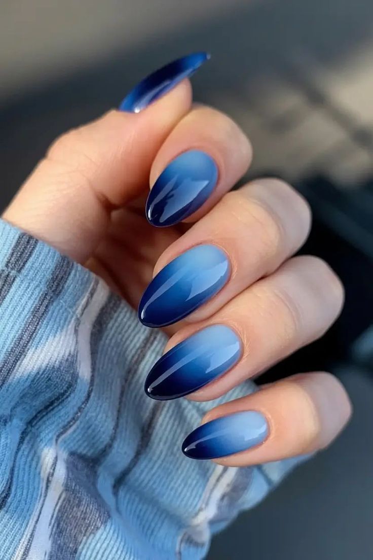 Deep blue ombré almond nails with glossy finish